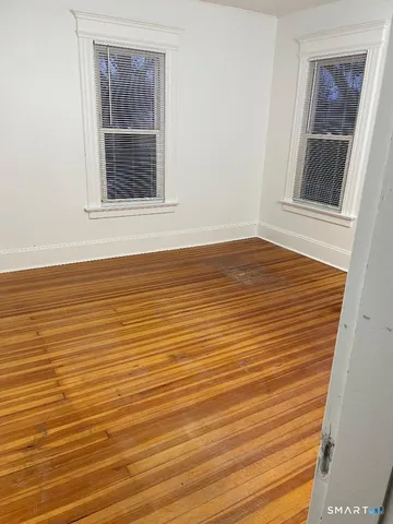 a view of empty room and wooden floor