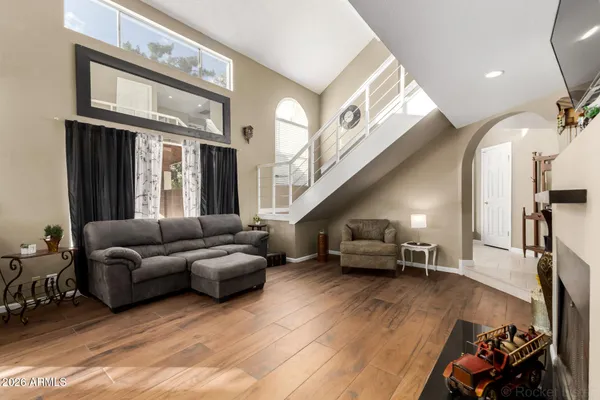 a living room with furniture and a chandelier