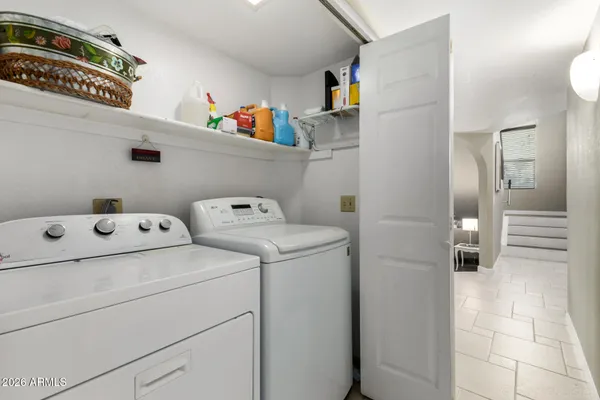 a view of storage and utility room with washer and dryer