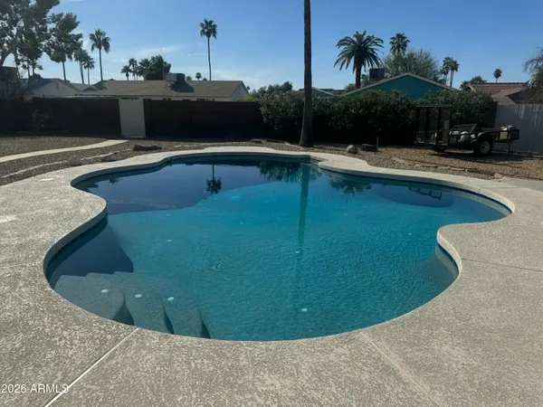 a view of a swimming pool with a yard