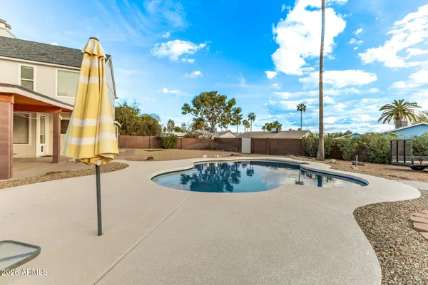 a view of a swimming pool with a lawn chairs