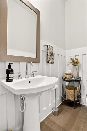 a bathroom with a toilet a sink and a mirror