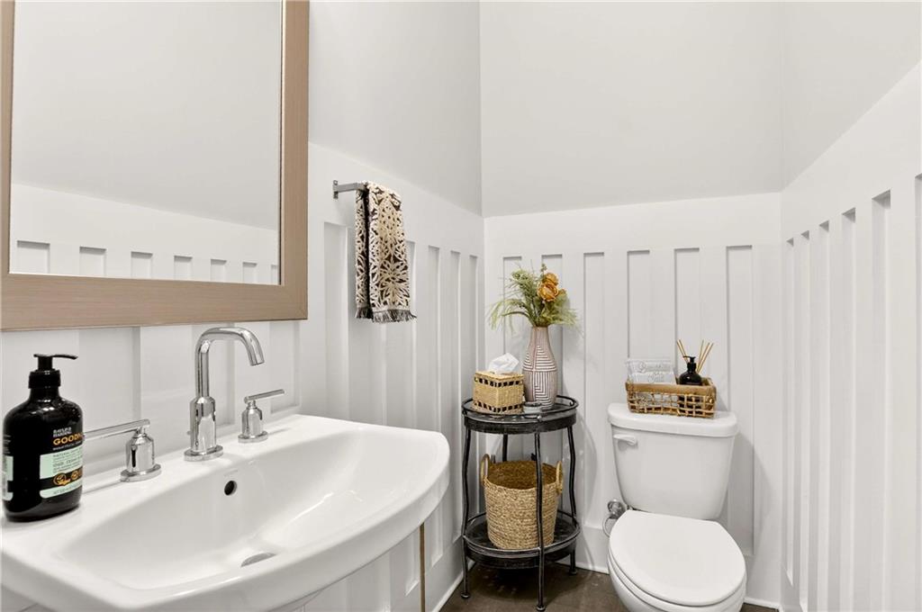 4302 Parkside Place Atlanta, GA 30342 - Photo 16 of 33 a bathroom with a toilet a sink and a mirror