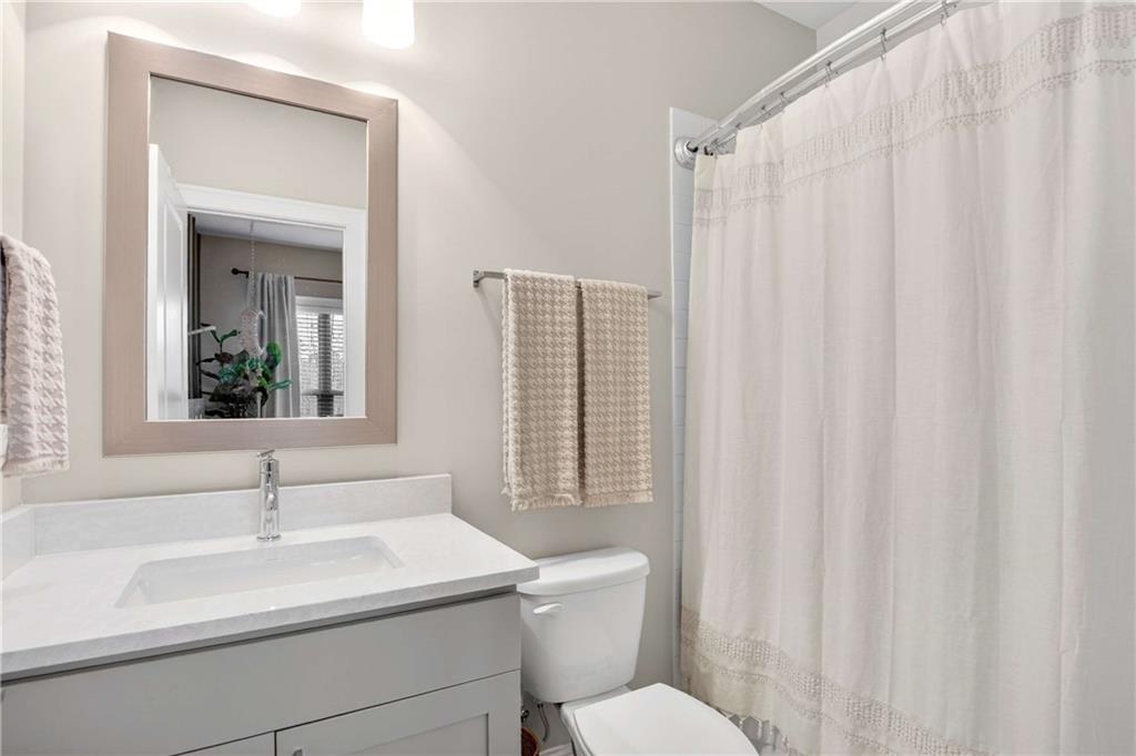 4302 Parkside Place Atlanta, GA 30342 - Photo 25 of 33 a bathroom with a sink a toilet and a mirror