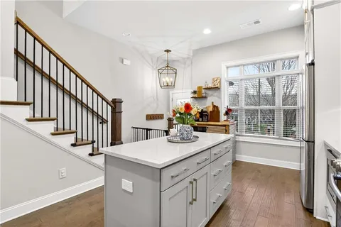 a kitchen with sink cabinets and wooden floor
