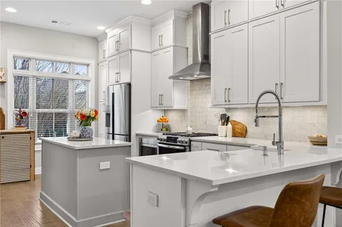 a kitchen with stainless steel appliances a sink and a white cabinets