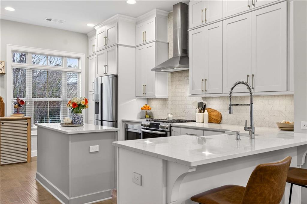 4302 Parkside Place Atlanta, GA 30342 - Photo 6 of 33 a kitchen with stainless steel appliances a sink and a white cabinets