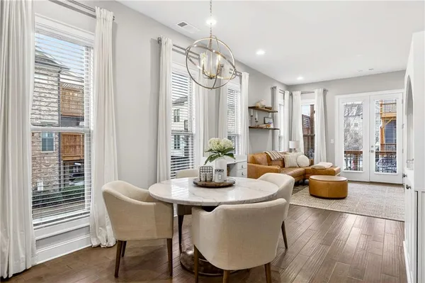 a dining room with furniture and wooden floor