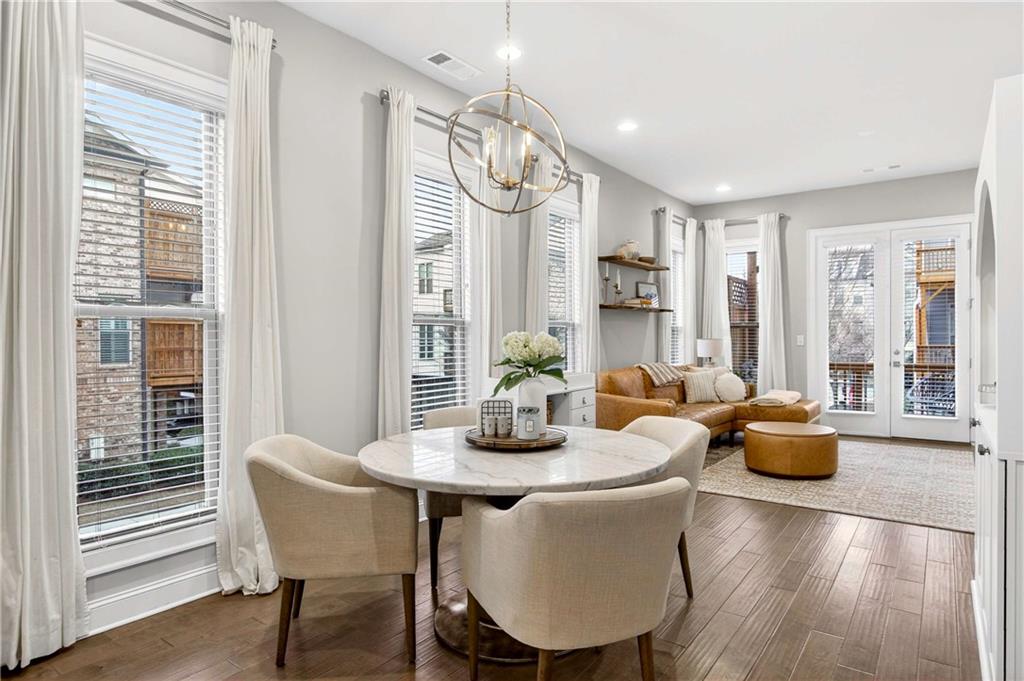 4302 Parkside Place Atlanta, GA 30342 - Photo 7 of 33 a dining room with furniture and wooden floor