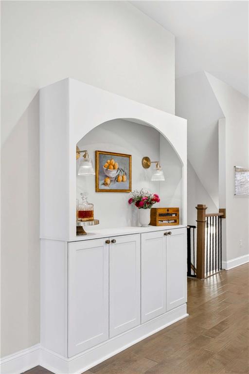 4302 Parkside Place Atlanta, GA 30342 - Photo 9 of 33 a kitchen with white cabinets and wooden floor