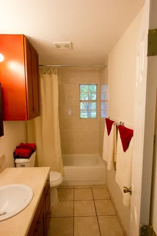 a bathroom with a tub sink and toilet