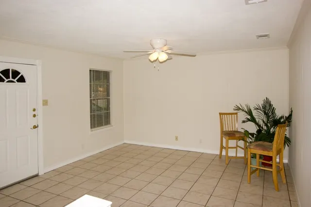 a view of a livingroom with furniture and chandelier fan