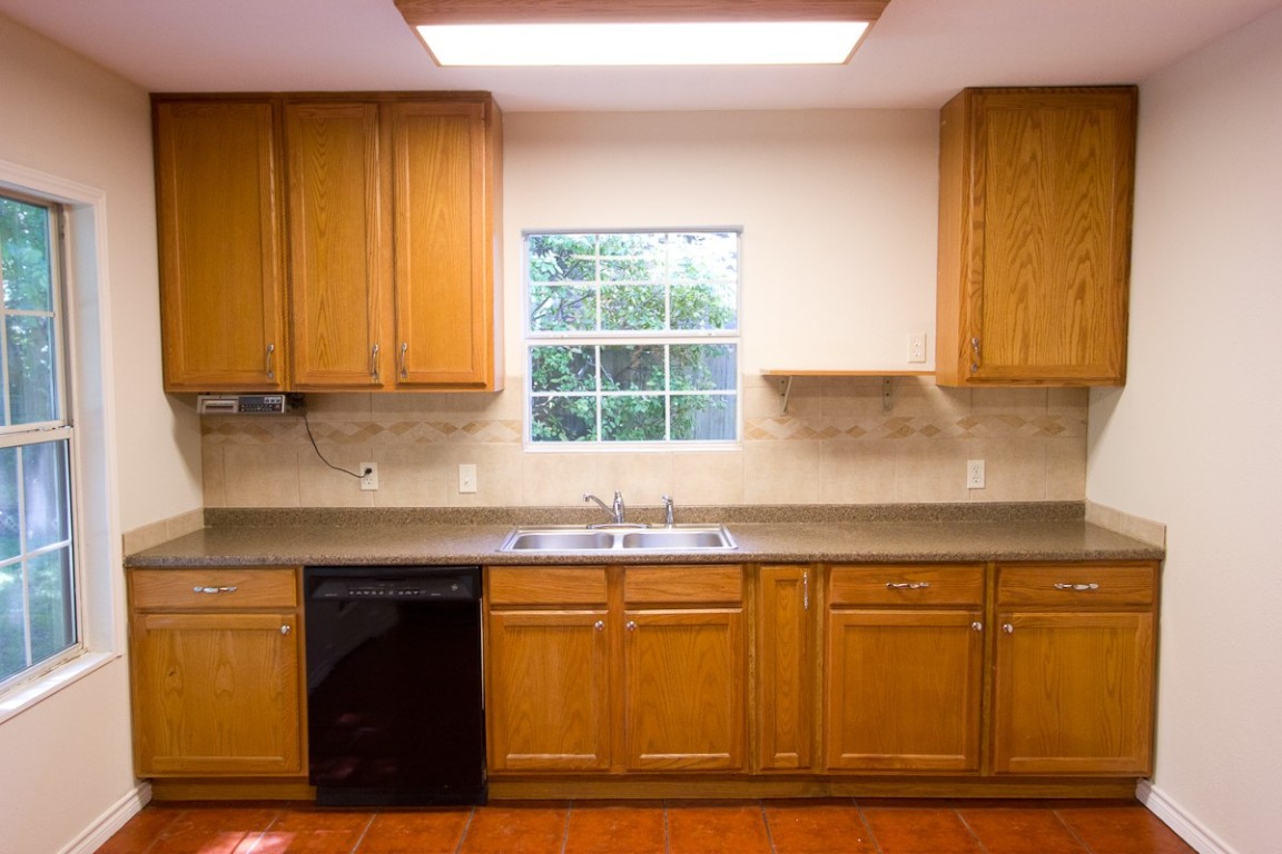 5901 South 1st Street Austin, TX 78745 - Photo 8 of 19 a kitchen with granite countertop cabinets and window