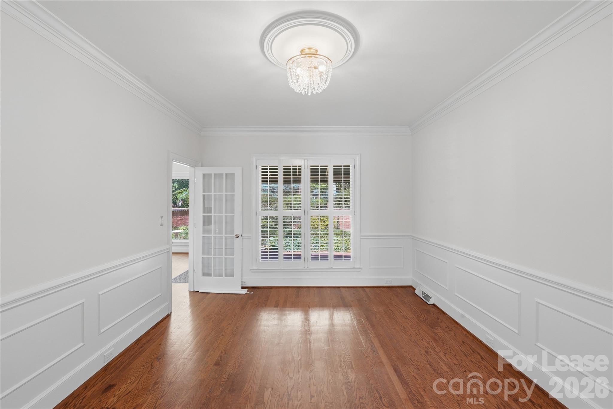 5906 Sharon Hills Road Charlotte, NC 28210 - Photo 11 of 30 an empty room with wooden floor and windows
