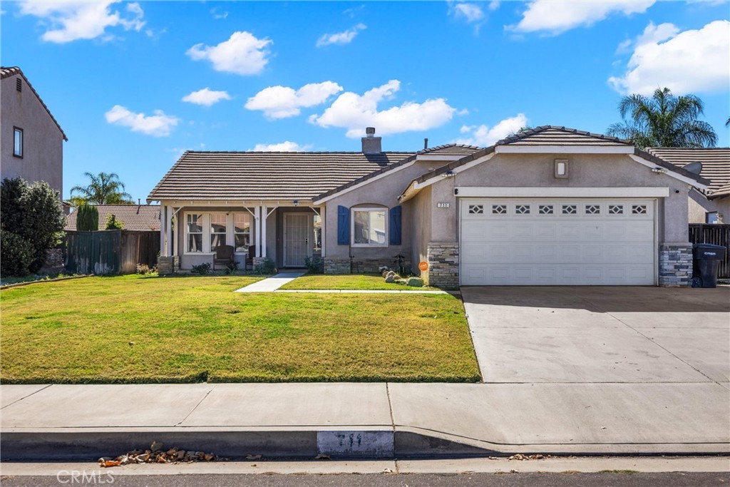 711 Myrtle Avenue Perris, CA 92571 - Photo 1 of 28 a front view of a house with a garden