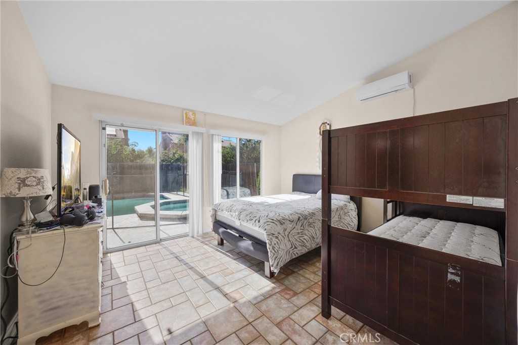 711 Myrtle Avenue Perris, CA 92571 - Photo 12 of 28 a bedroom with a bed and large window