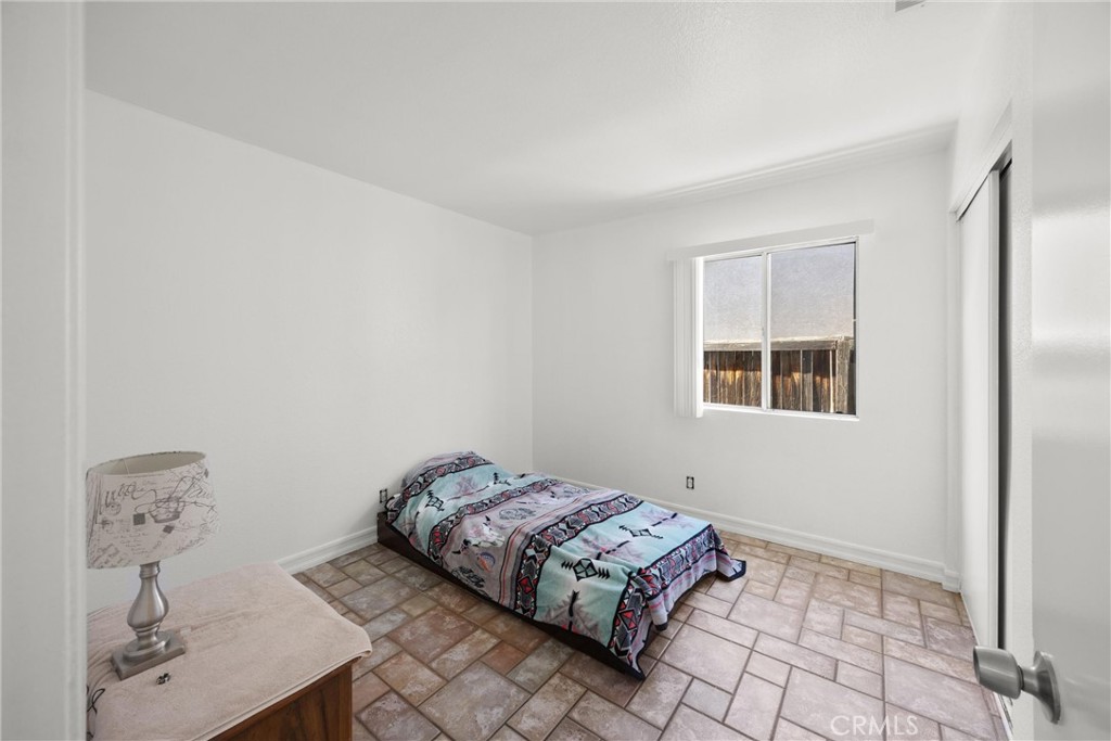 711 Myrtle Avenue Perris, CA 92571 - Photo 8 of 28 a bedroom with a bed and a window