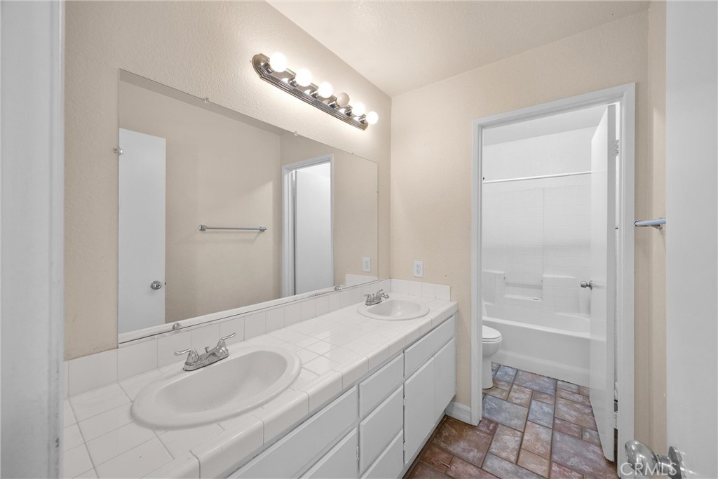 711 Myrtle Avenue Perris, CA 92571 - Photo 9 of 28 a bathroom with a sink a vanity and a mirror