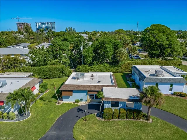 a aerial view of a house with a yard table and chairs