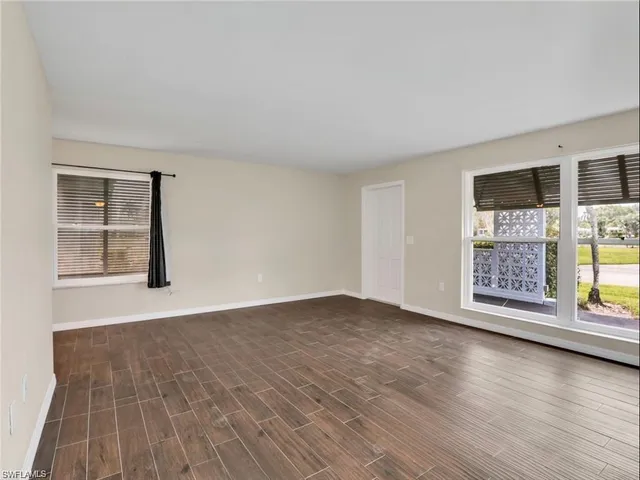 wooden floor in an empty room with a window