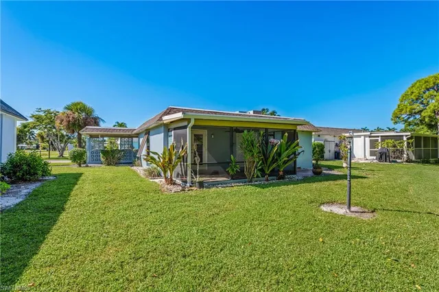 a view of house with backyard