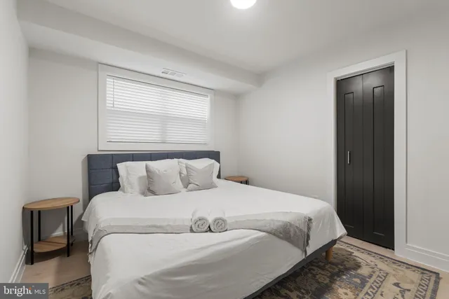 a bedroom with a large bed and a window