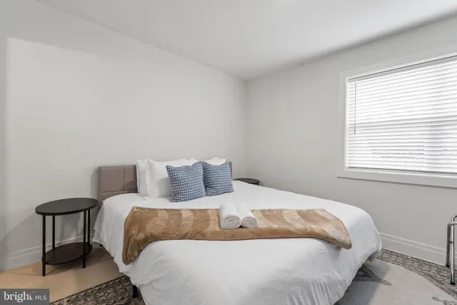 a bedroom with a bed and a table