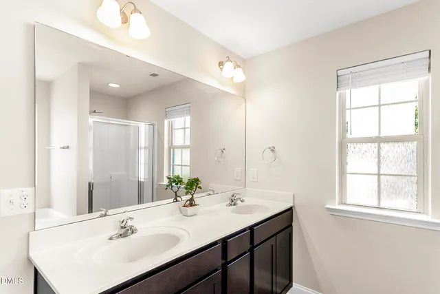 a bathroom with a sink double vanity and a mirror
