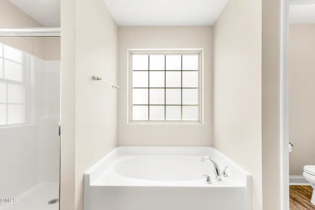 a white bath tub sitting next to a window