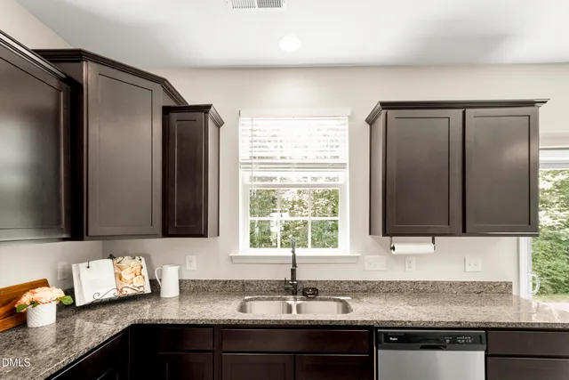 a view of an empty room with a window and a fireplace