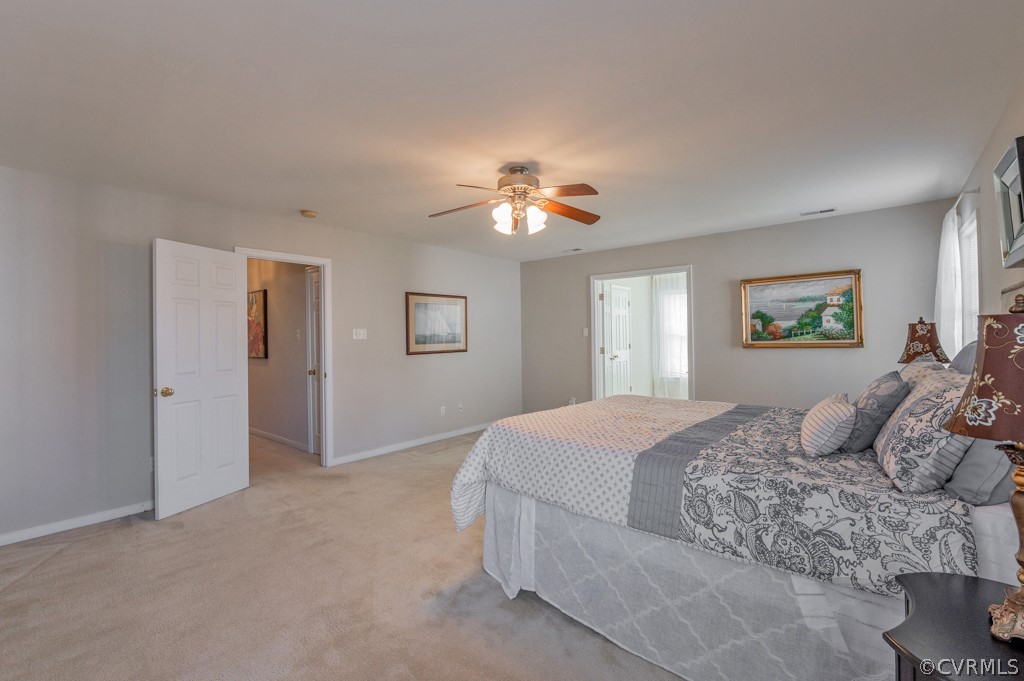 1313 Goswick Ridge Road Midlothian, VA 23114 - Photo 19 of 31 a bedroom with a large bed and a chandelier