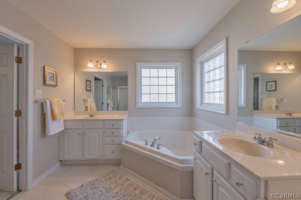 1313 Goswick Ridge Road Midlothian, VA 23114 - Photo 21 of 31 a bathroom with a tub sink and mirror