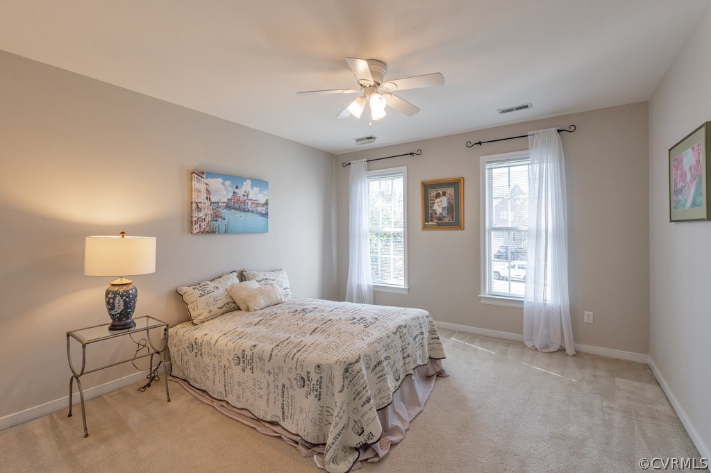 1313 Goswick Ridge Road Midlothian, VA 23114 - Photo 24 of 31 a bedroom with a large bed and a chandelier