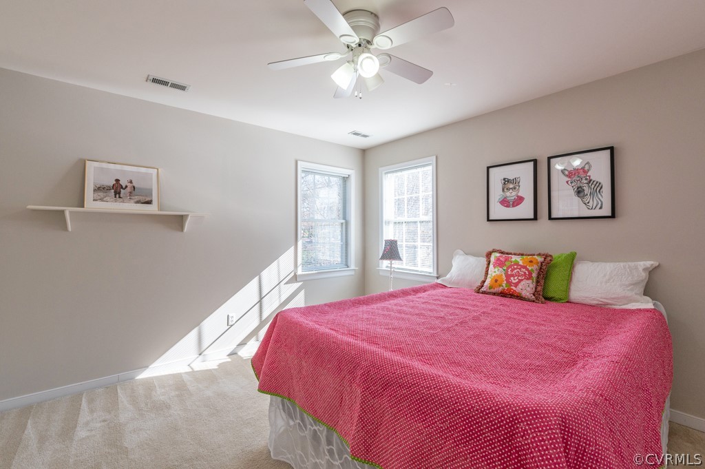 1313 Goswick Ridge Road Midlothian, VA 23114 - Photo 25 of 31 a bedroom with a large bed and a chandelier