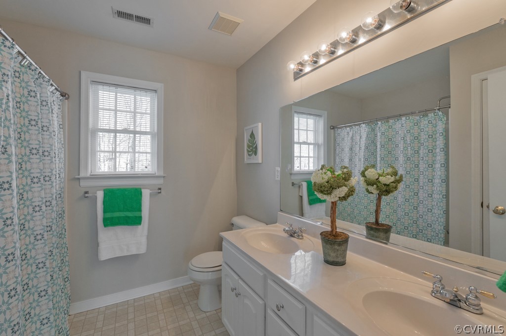 1313 Goswick Ridge Road Midlothian, VA 23114 - Photo 26 of 31 a bathroom with a toilet a sink and mirror