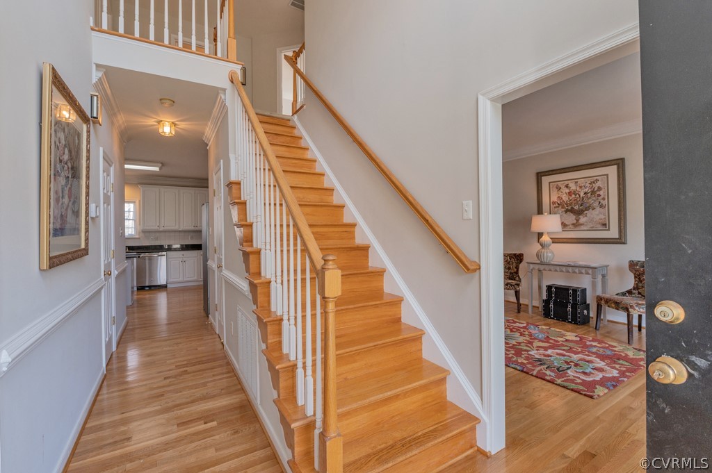 1313 Goswick Ridge Road Midlothian, VA 23114 - Photo 3 of 31 a view of staircase with lots of frames on wall and a dining table