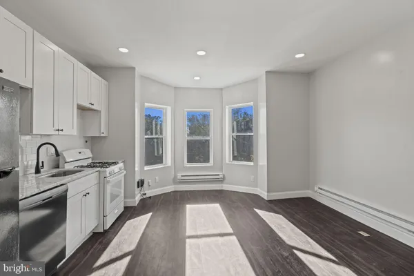 a kitchen with stainless steel appliances a refrigerator and a stove top oven