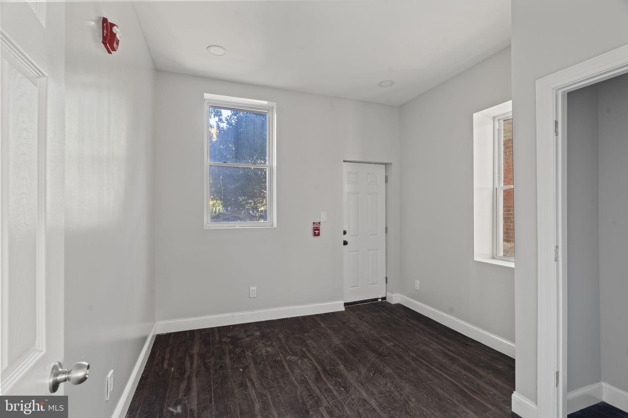 5237 Chester Avenue Philadelphia, PA 19143 - Photo 18 of 41 an empty room with wooden floor and windows