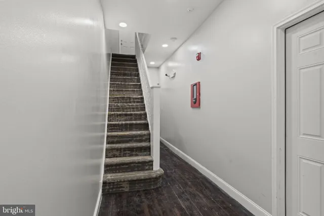 a view of entryway and hall with wooden floor