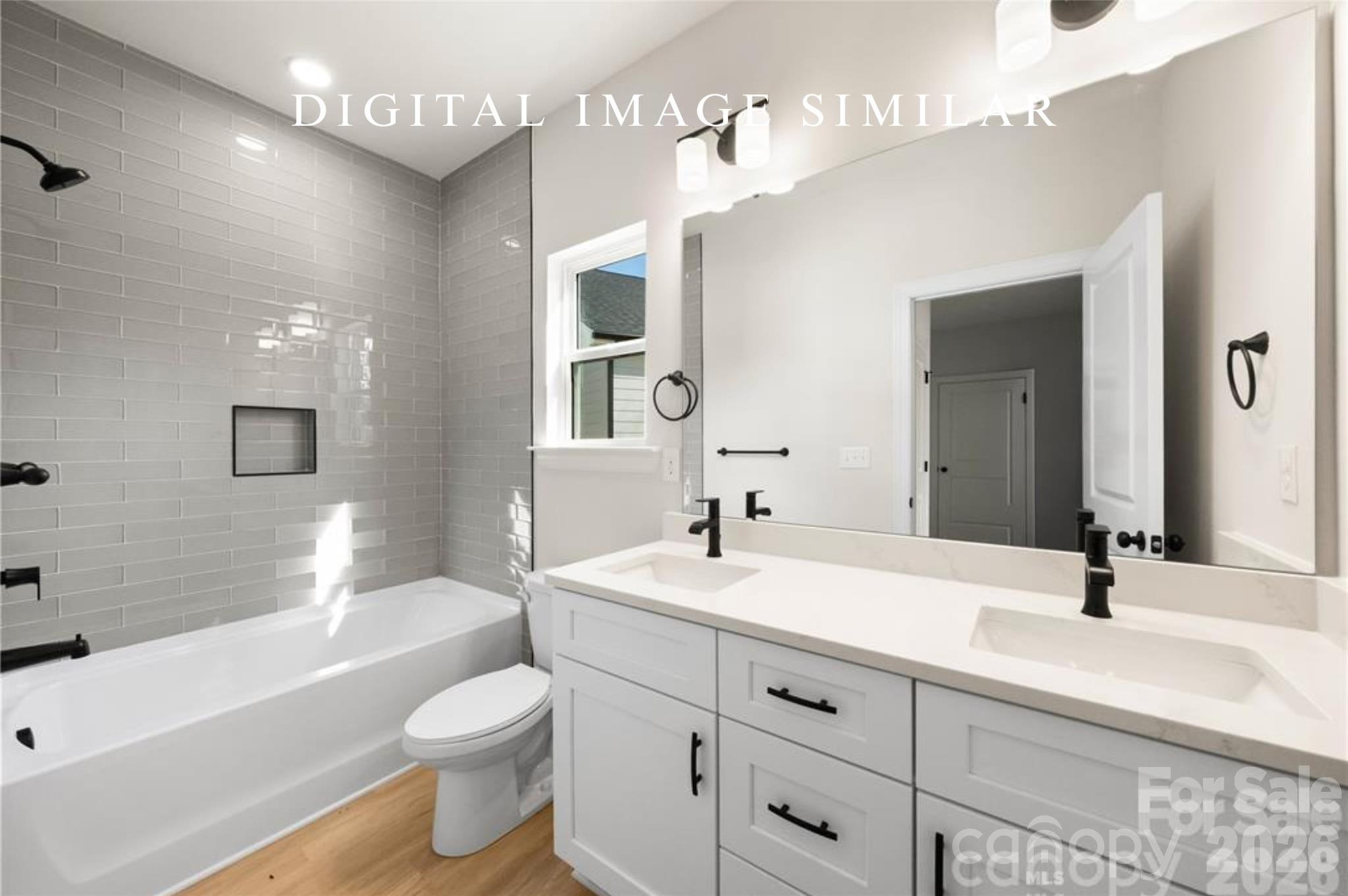 2928 Mulberry Church Road Charlotte, NC 28208 - Photo 36 of 43 a bathroom with a double vanity sink toilet mirror and bathtub