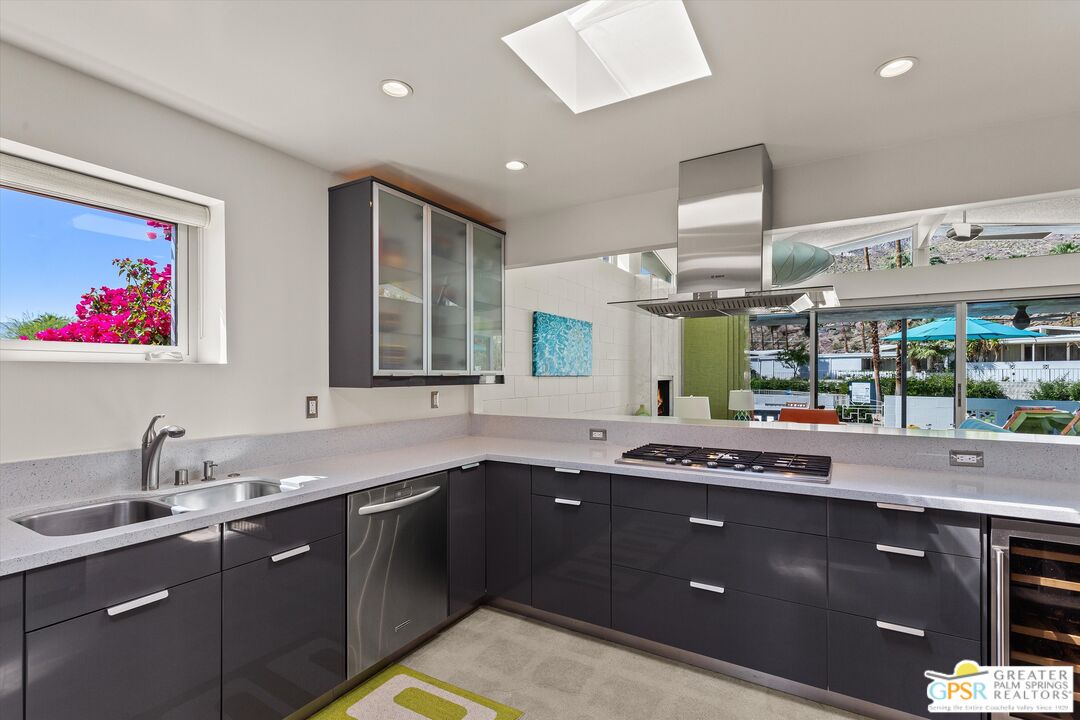 233 Toro Circle Palm Springs, CA 92264 - Photo 18 of 39 a kitchen with a sink stove and cabinets