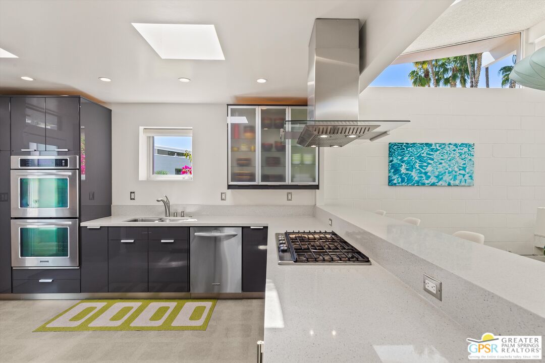 233 Toro Circle Palm Springs, CA 92264 - Photo 19 of 39 a kitchen with a sink and a stove top oven