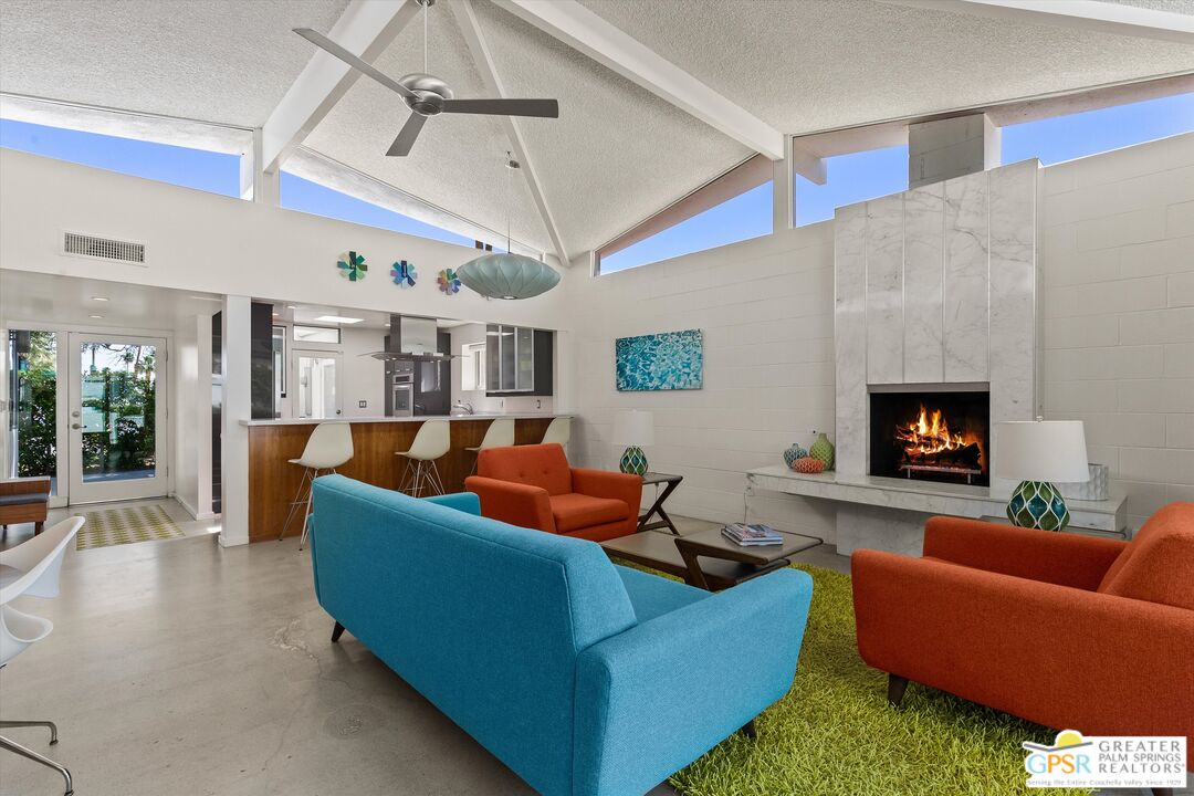 233 Toro Circle Palm Springs, CA 92264 - Photo 2 of 39 a living room with furniture wooden floor and a fireplace