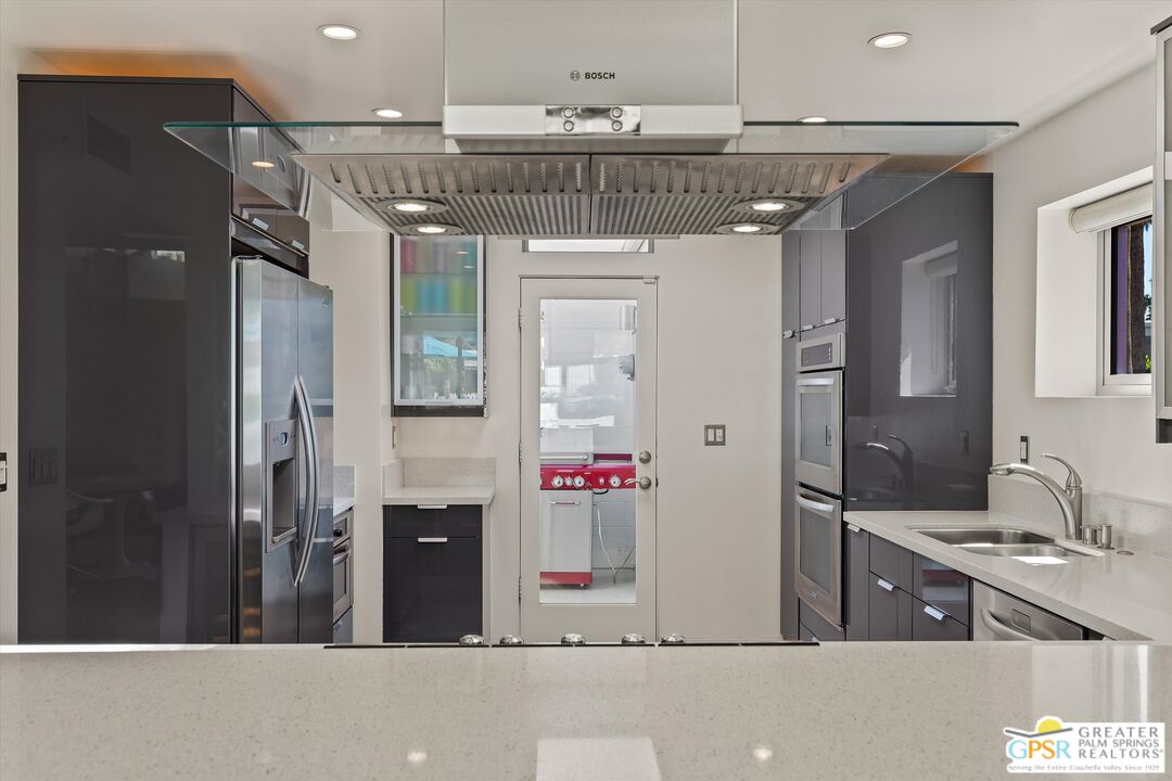 233 Toro Circle Palm Springs, CA 92264 - Photo 21 of 39 a view of a bathroom with a sink and mirror