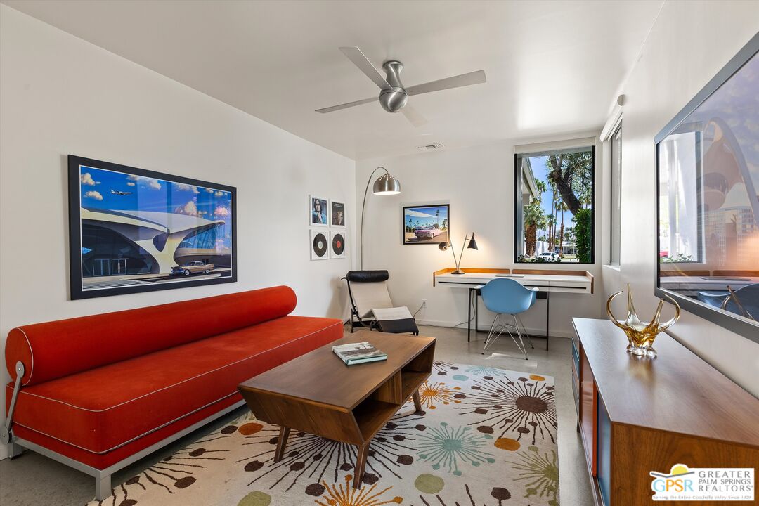 233 Toro Circle Palm Springs, CA 92264 - Photo 24 of 39 a living room with furniture a rug and a wall painting