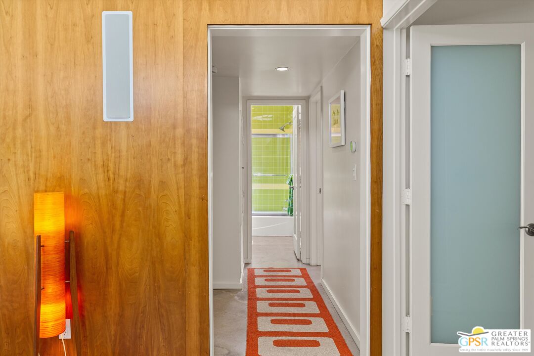 233 Toro Circle Palm Springs, CA 92264 - Photo 26 of 39 a view of a hallway with wooden floor and staircase