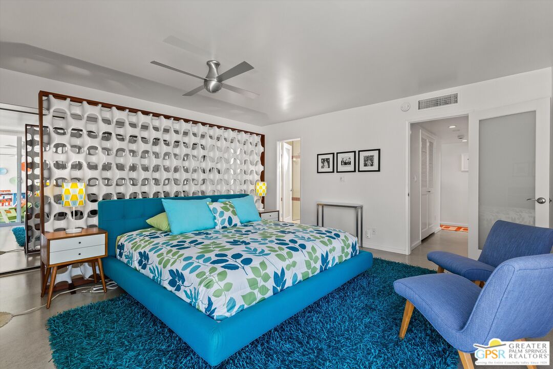 233 Toro Circle Palm Springs, CA 92264 - Photo 27 of 39 a bedroom with a bed a couch and a dresser