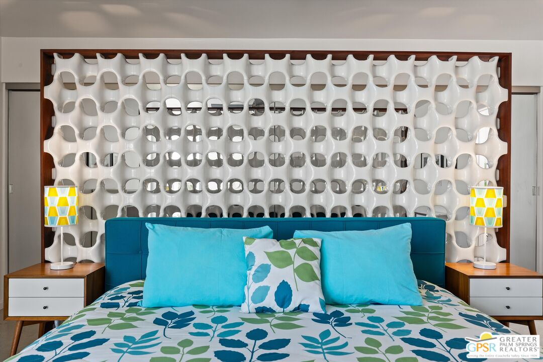 233 Toro Circle Palm Springs, CA 92264 - Photo 28 of 39 a bedroom with a bed and a chair