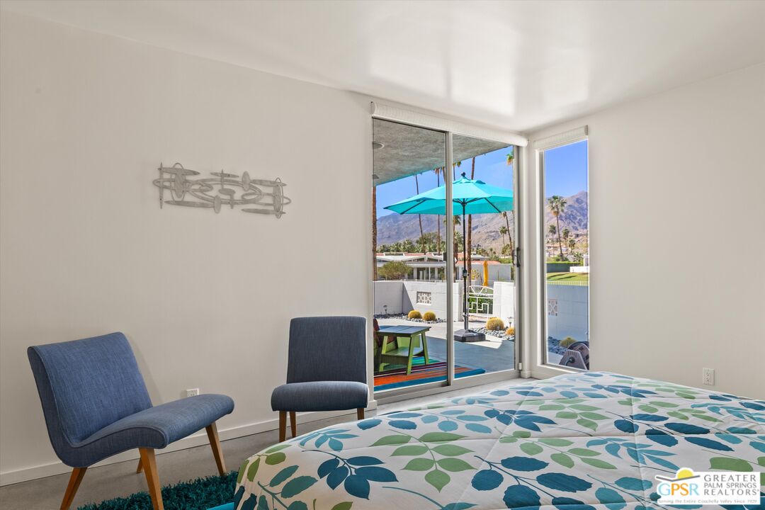 233 Toro Circle Palm Springs, CA 92264 - Photo 29 of 39 a bedroom with furniture and a window
