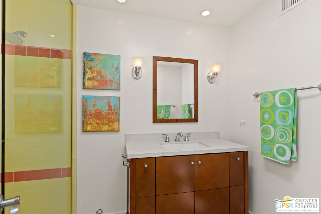 233 Toro Circle Palm Springs, CA 92264 - Photo 30 of 39 a bathroom with a sink and a mirror